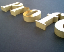 Side view of 3-D lettering 12 inch thick with brushed gold faces